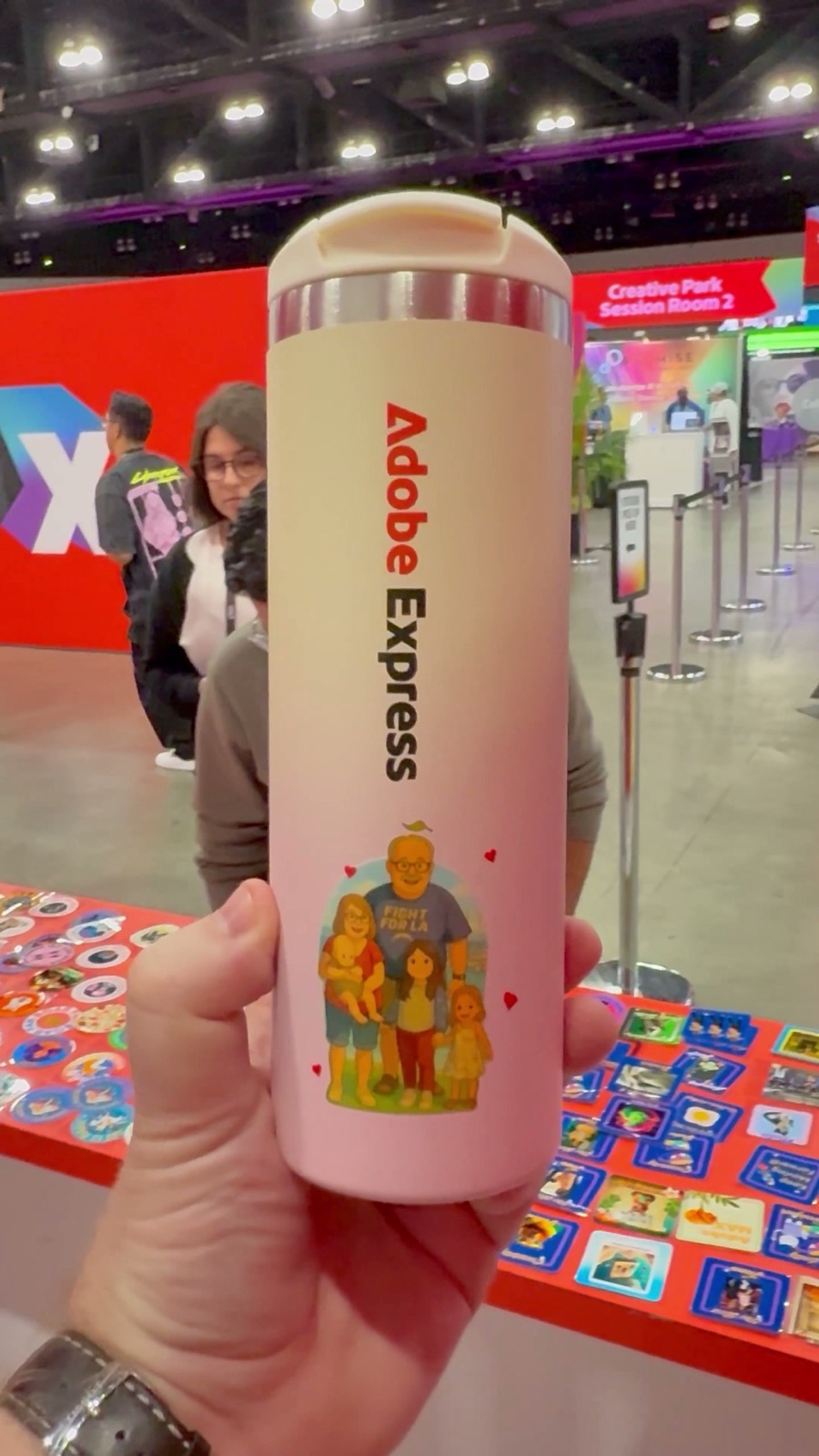 Attendee holding a travel tumbler customized with a full-color UV DTF graphic